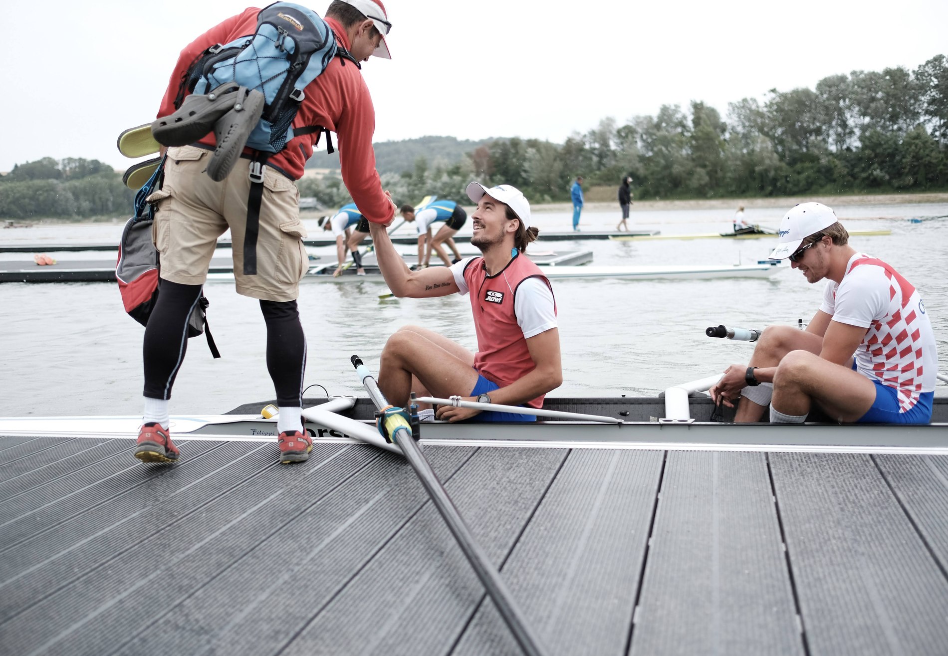 Karlo congratulating a rower on the dock